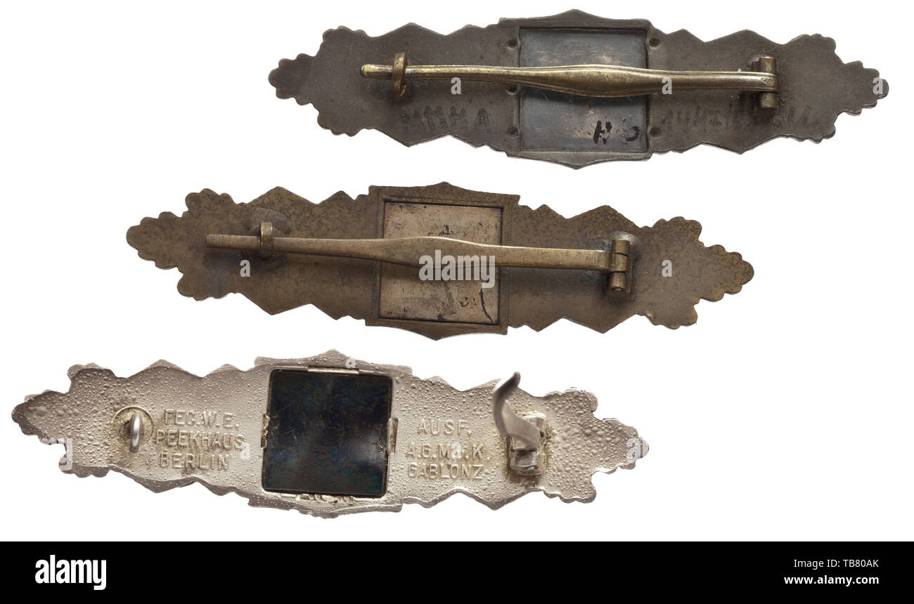 Close Combat Clasps - two of Grade I for 15- and one of Grade II for 30 close combat days, Silver clasp (Grade II) by the Arbeitsgemeinschaft Metall und Kunststoff in Gablonz (A.G.M.u.K.) in the issue of large font and a crimped blued steel reverse plate (reaffixed during time of use). Heavily silvered with blistering, in very good condition. Width 97.5 mm. Weight 35.8 g. Also, a Grade I clasp in bronze produced in bronzed zinc by maker Steinhauer & Lück in Lüdenscheid with full-waisted attachment pin. Width 97 mm. Weight 27.9 g. Further, a thus far unattributed Grade I cla, Editorial-Use-Only Stock Photo