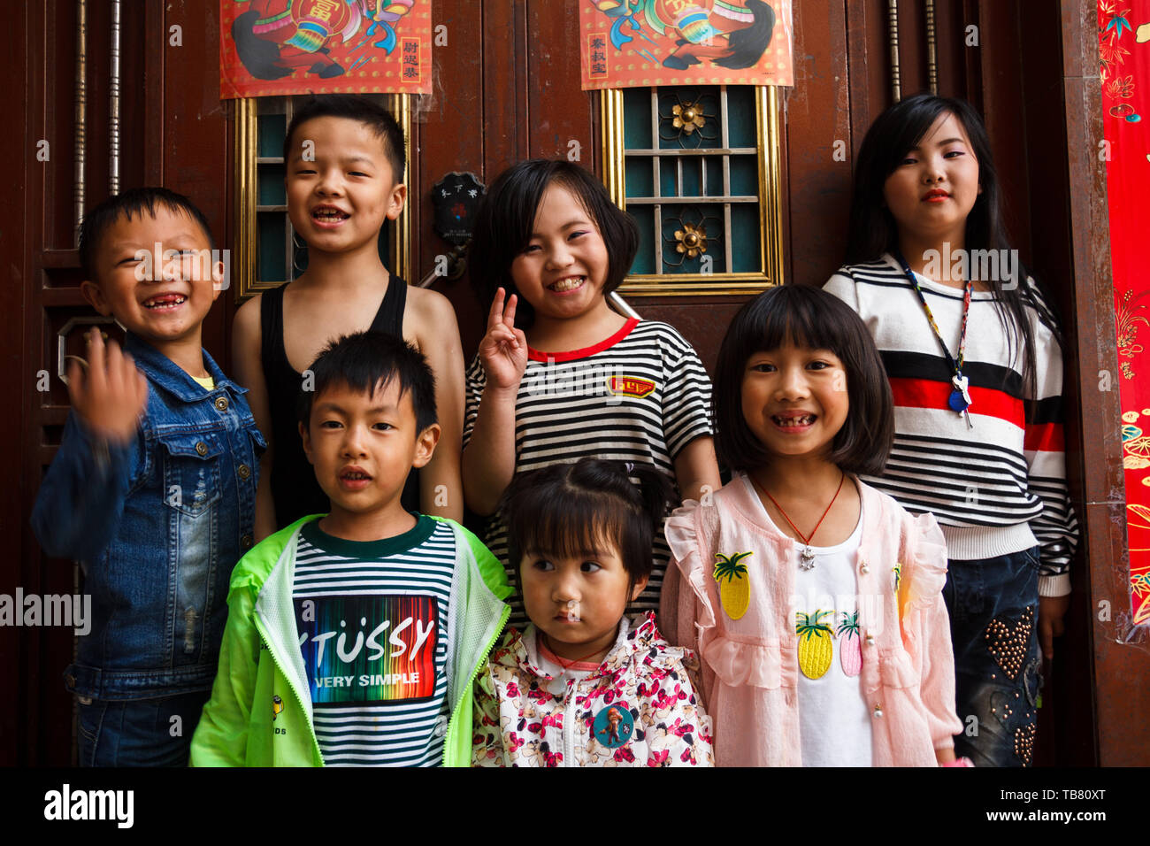 China/ Kunming 17-07-2017 Group of Chinese poor neighbourhood kids pose for a group picture Stock Photo