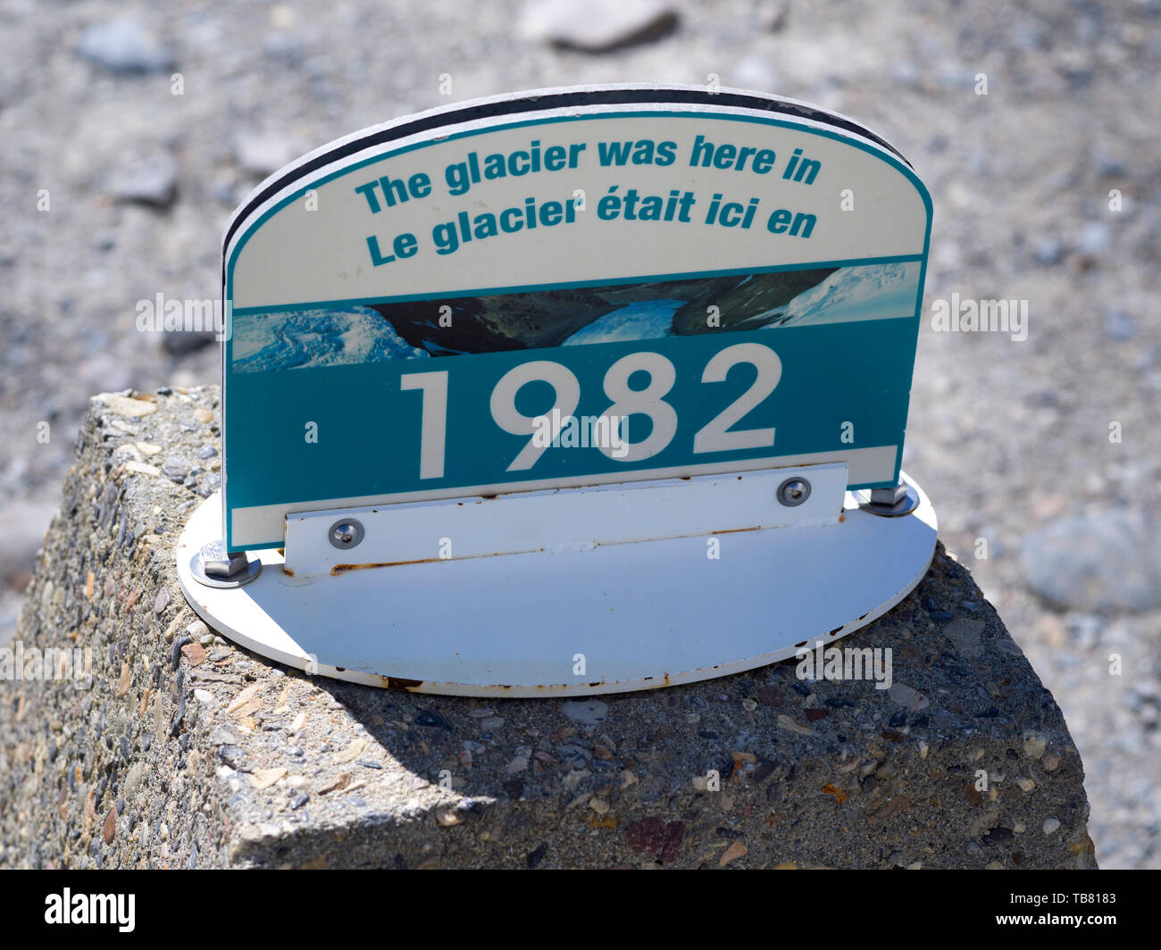 Signboard reading 'The glacier was here in 1982' below foot Athabasca Glacier's present day terminus, Icefields Parkway, Jasper, Alberta, Canada Stock Photo