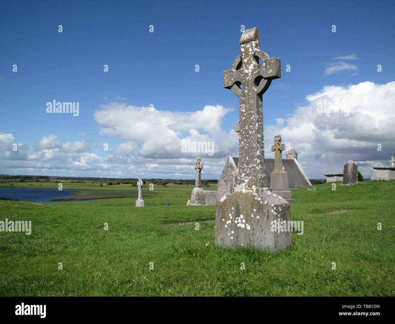 Celtic cross and monastic archeological site of Clonmacnoise in Ireland Stock Photo