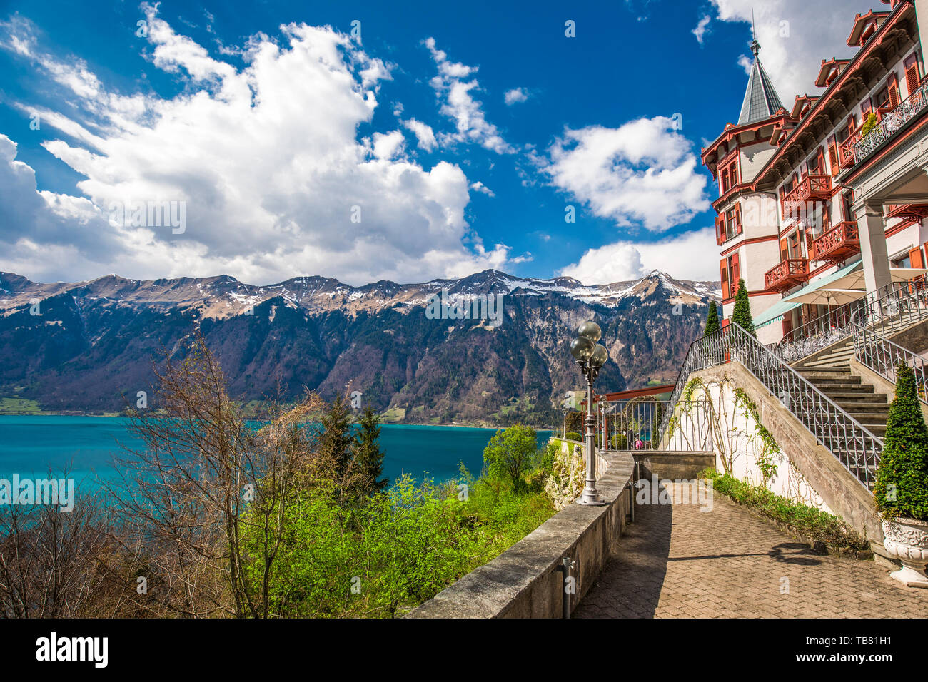 BRIENZ, April 21, 2019 - Lake Brienz with Giessbach waterfall by Interlaken with the Swiss Alps covered by snow in the background, Switzerland, Europe Stock Photo