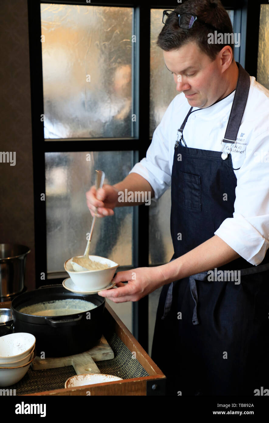 Chef Filling A Bowl Of Wild Rice Chowder For Customer In Cedarstone