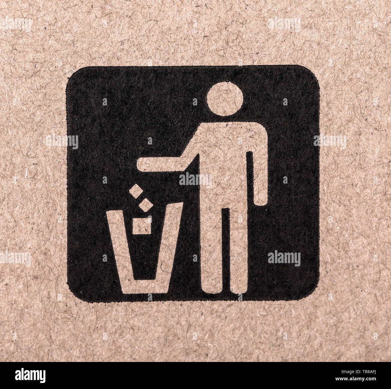 figure of person throwing garbage into a trash can Stock Photo
