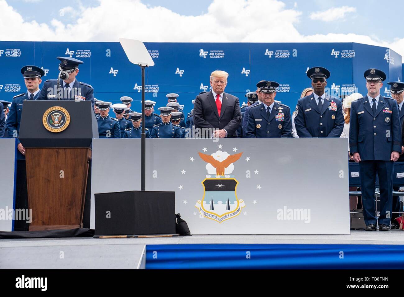 U.S President Donald Trump stands for the invocation during the U.S. Air Force Academy Graduation Ceremony at the USAF Academy Falcon Stadium May 30, 2019 in Colorado Springs, Colorado. Credit: Planetpix/Alamy Live News Stock Photo