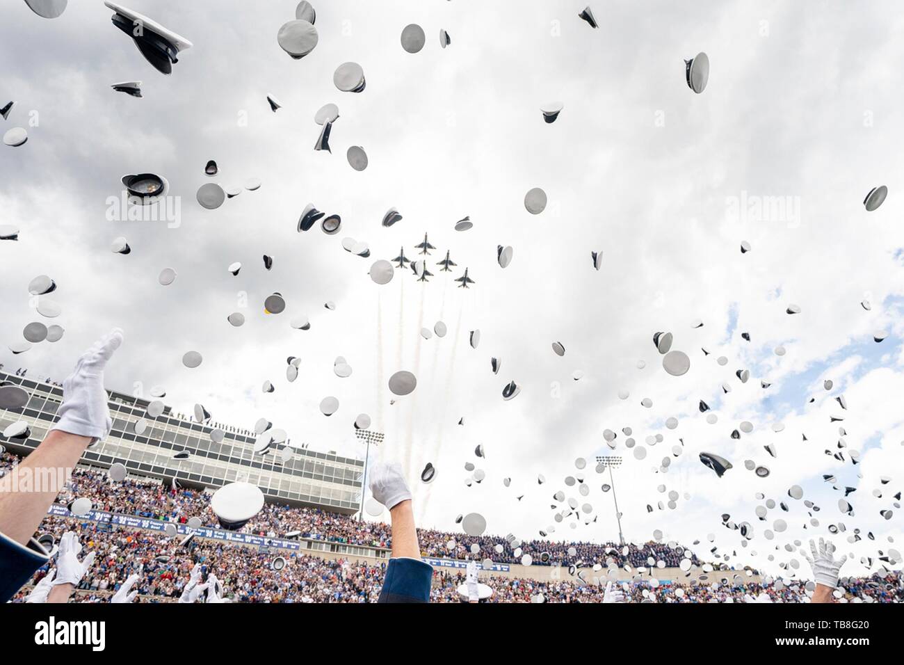 U.S. Air Force Academy cadets celebrate by tossing their hats into the air at the conclusion of graduation ceremonies at the USAF Academy Falcon Stadium May 30, 2019 in Colorado Springs, Colorado. U.S. President Donald Trump gave the commencement address to the more than 900 graduates. Credit: Planetpix/Alamy Live News Stock Photo