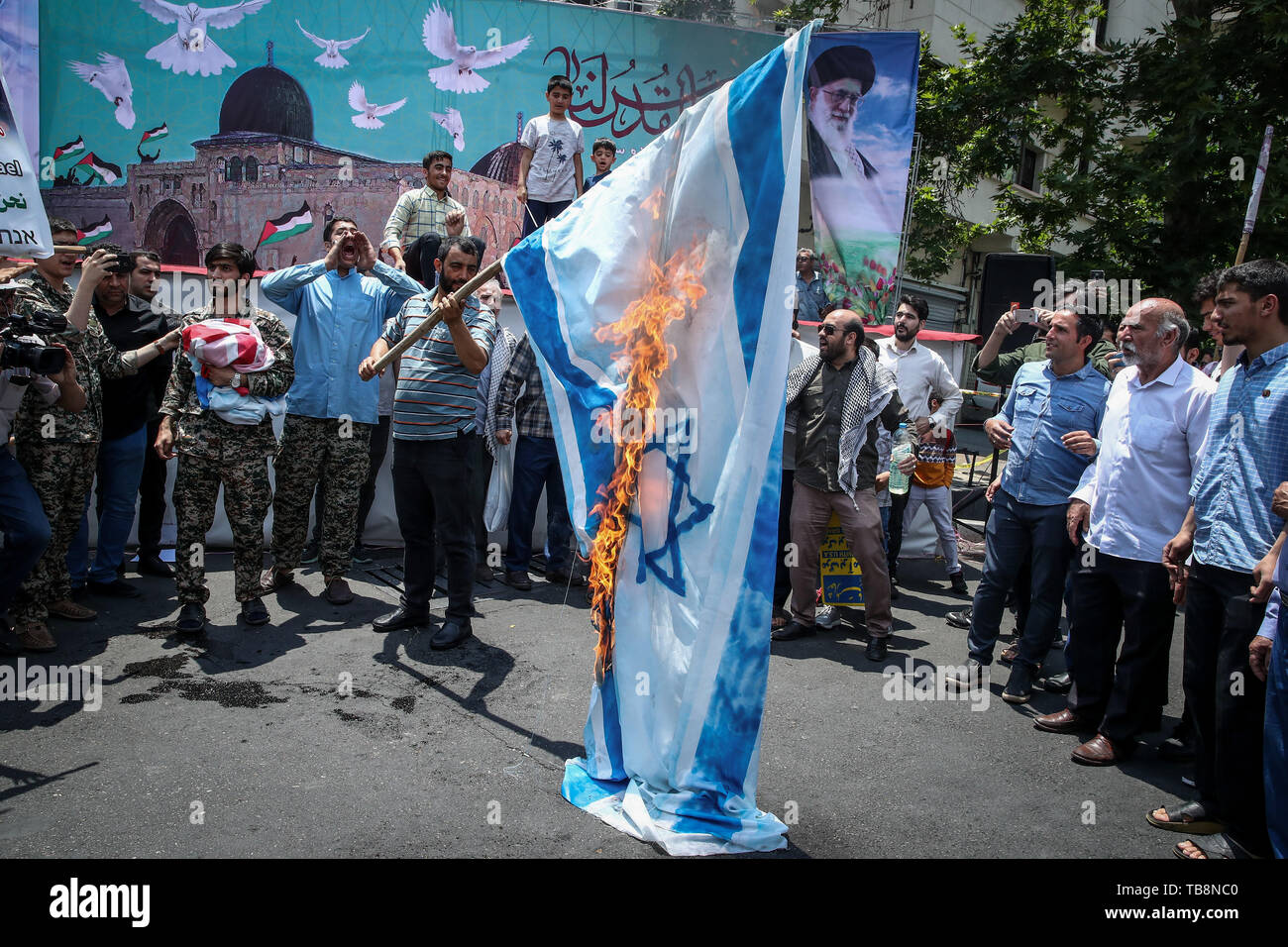 Tehran, Iran. 31st May, 2019. An Iranian man burns the Israeli flag during a protest marking the annual al-Quds Day (Jerusalem Day) on the last Friday of the Muslim holy month of Ramadan. Credit: Saeid Zareian/dpa/Alamy Live News Stock Photo