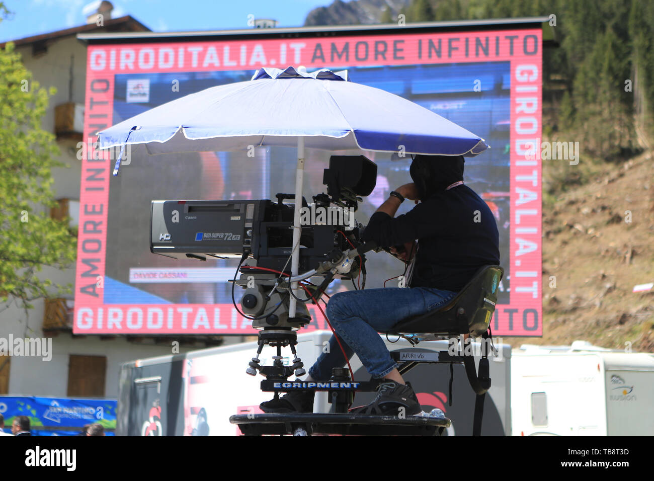 Treviso to San Martino di Castrozza, Italy. 31st May 2019, The Giro D Italia  Cycling tour, stage 19; Rai TV crew in front of a huge Tv screen under an  umbrella Credit: