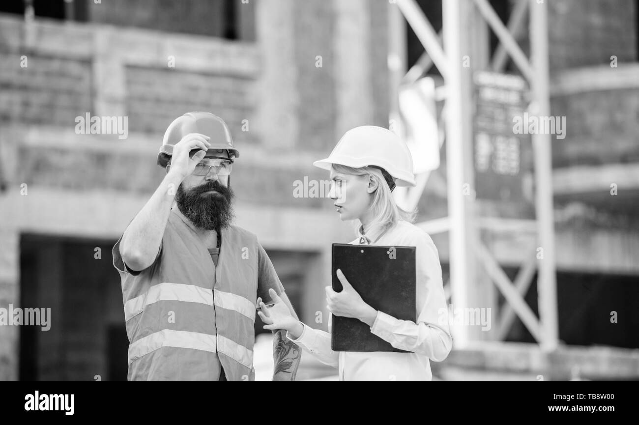 Inspector and bearded brutal builder discuss construction progress ...