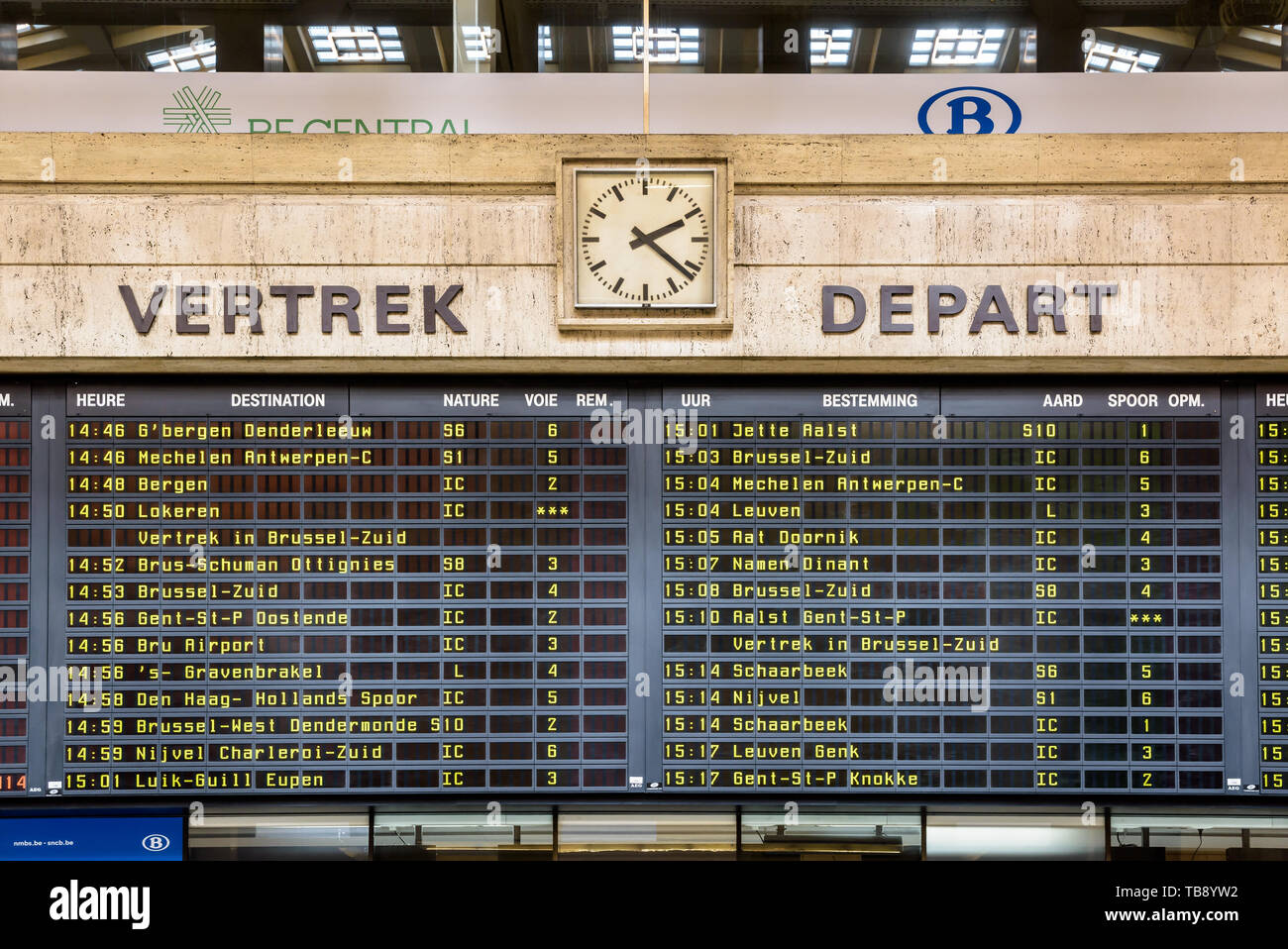 The departures board in Brussels Central station displays the names of the destinations alternately in french and dutch. Stock Photo