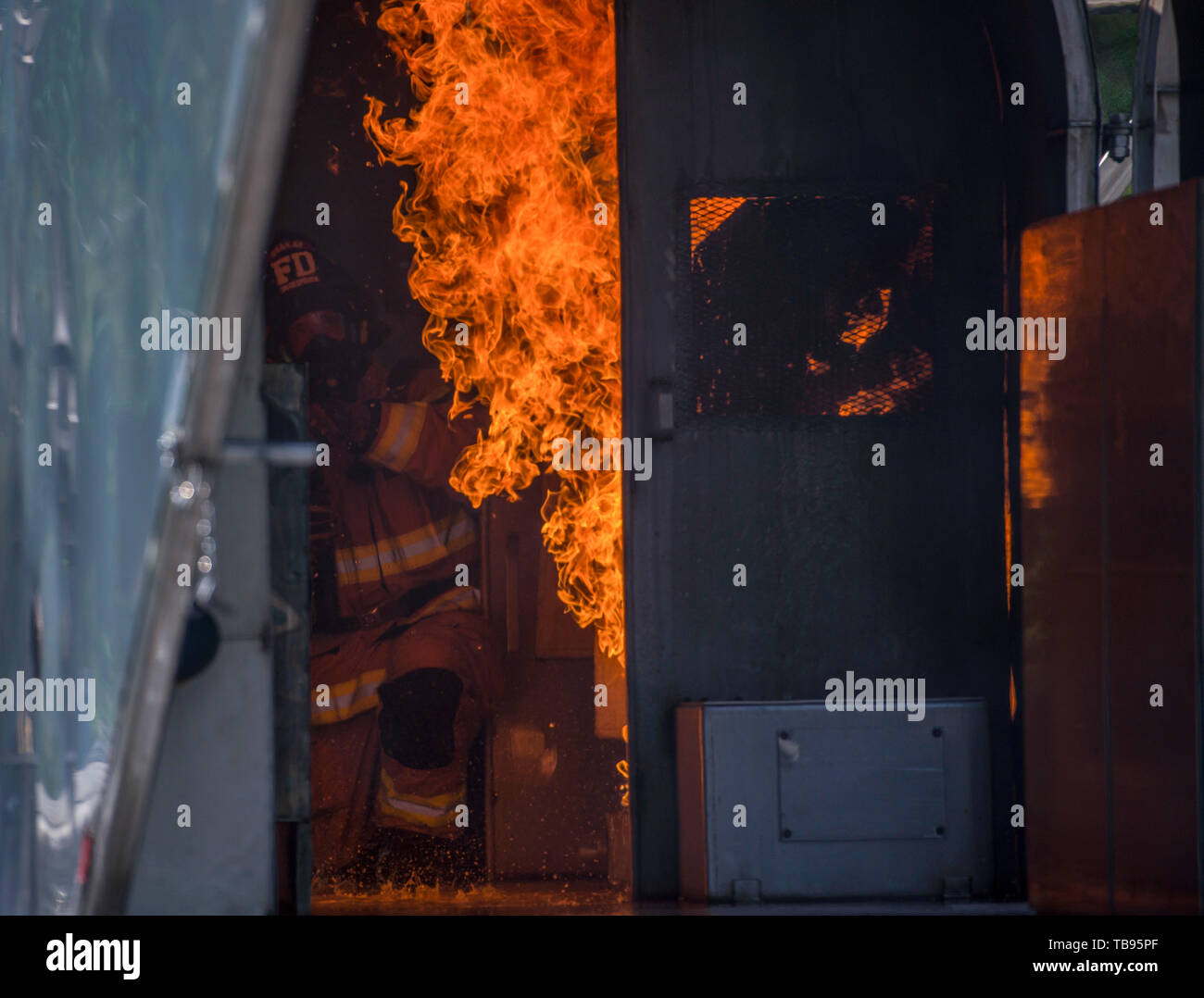 A firefighter assigned to the 628th Civil Engineer Squadron puts out a fire in a mobile aircraft fire training unit May 27, 2019, at Joint Base Charleston, S.C. JB Charleston’s fire department teamed with the Crash Fire Rescue Marines from Marine Corps Air Station, Beaufort, S.C., to conduct Joint Mobile Aircraft Fire Training May 27-31, 2019, at JB Charleston’s Fire Department training grounds. This training not only fulfilled an annual requirement for mission capable firefighters but it also highlighted the importance of collaboration between joint mission partners throughout the Lowcountry. Stock Photo