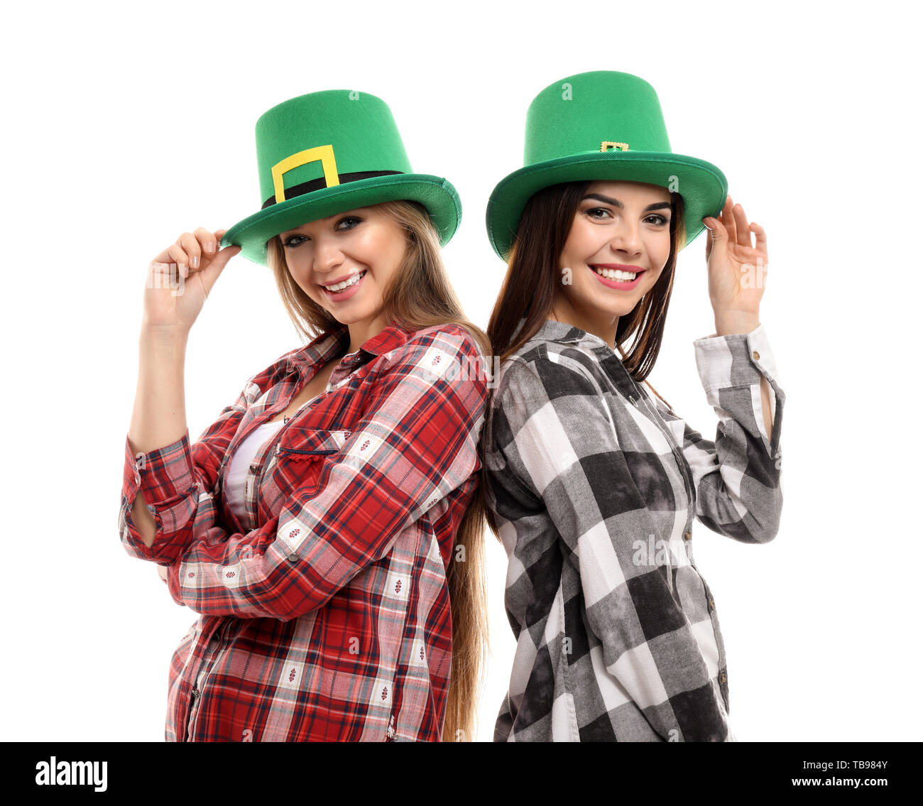 Beautiful young women in green hats on white background. St. Patrick's Day celebration Stock Photo