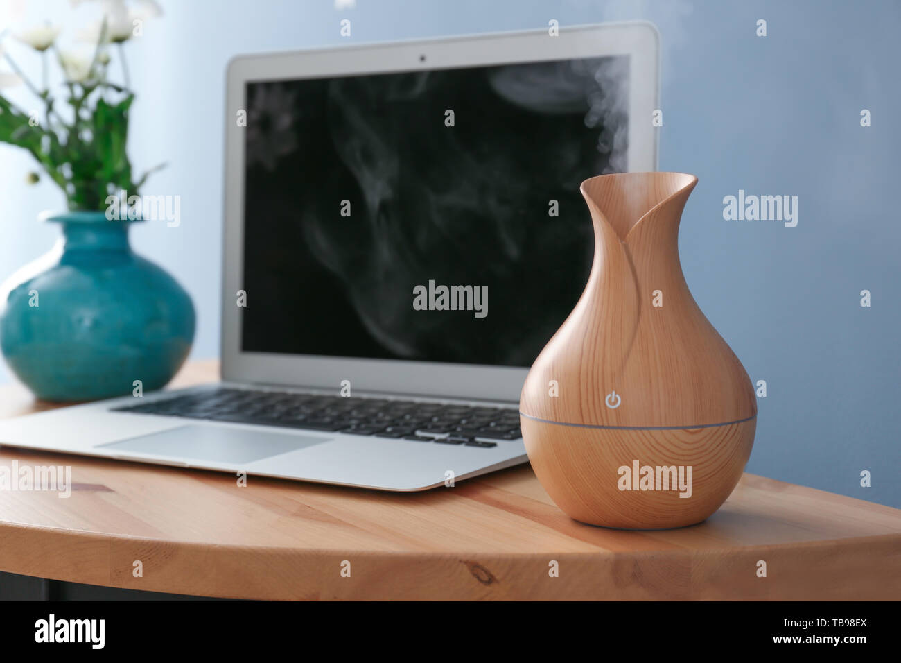 Aroma oil diffuser on table in room Stock Photo