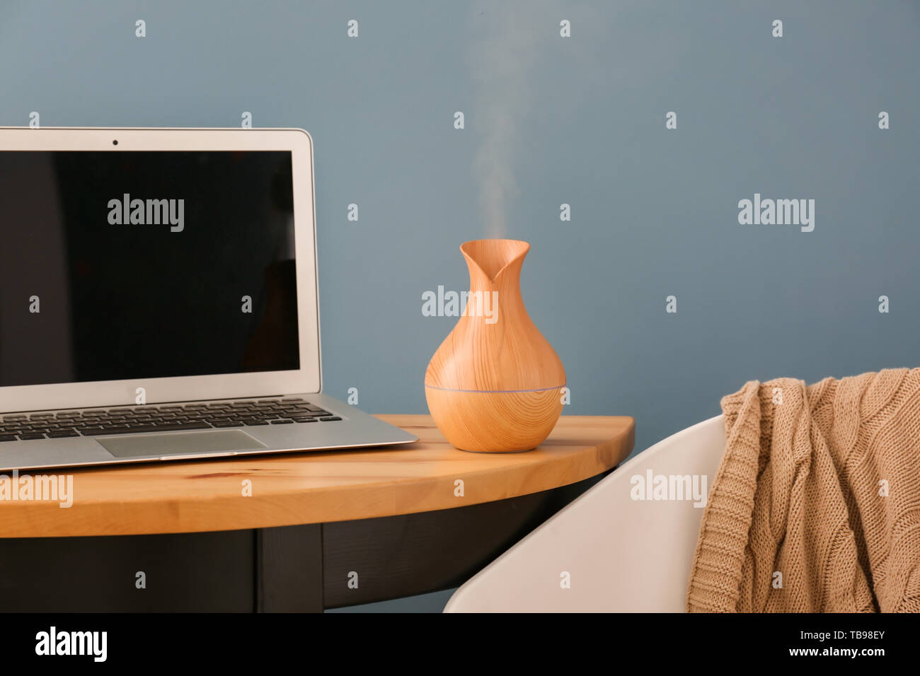 Aroma oil diffuser on table in room Stock Photo
