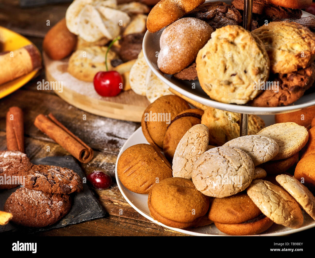 Oatmeal cookies, crispy wafer rolls on tier cake stand Stock Photo