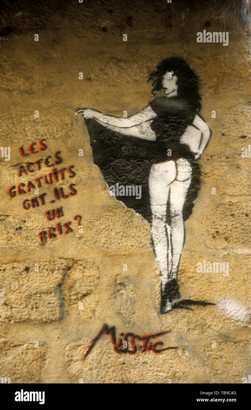 Graffiti by Miss.Tic a well-known Parisien artist.  The text reads 'Les actes gratuites ont ils?' or 'Do free acts have a price?' Stock Photo