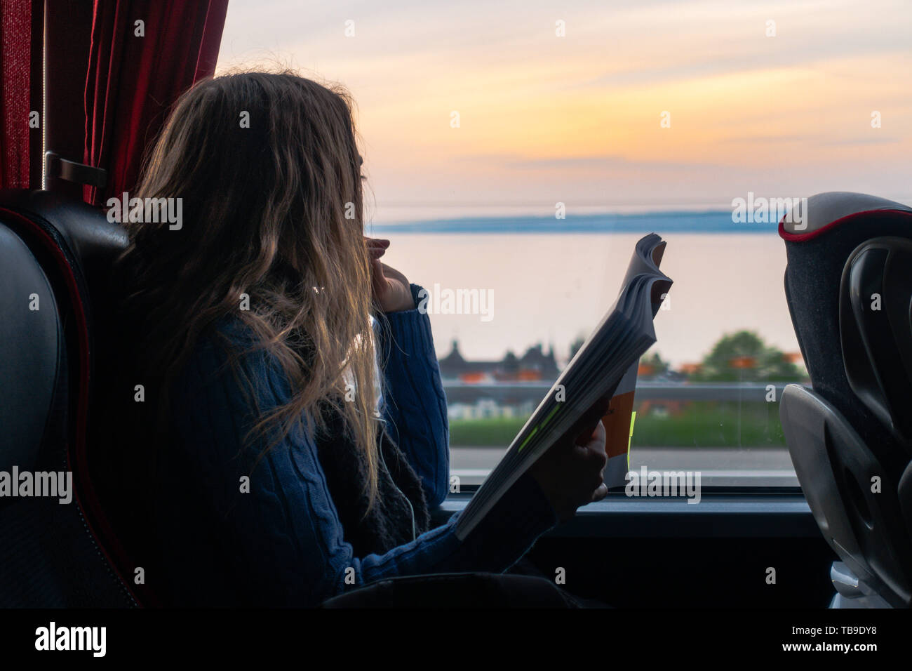 Silhouette of woman and girl looking out window hi-res stock ...