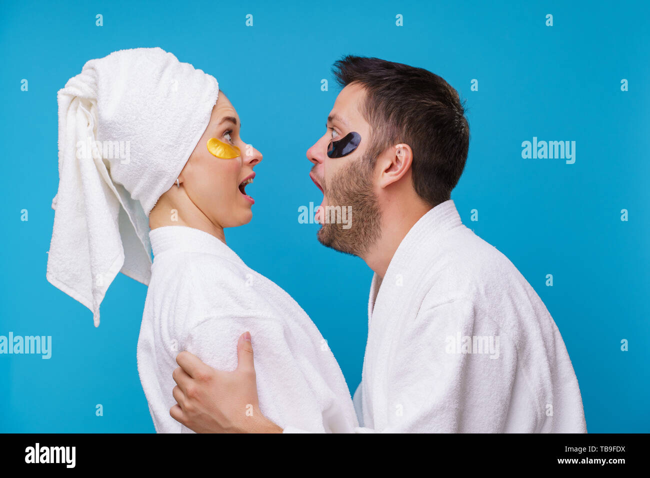 Image on side of man and woman with gel pads under eyes and in white robe Stock Photo