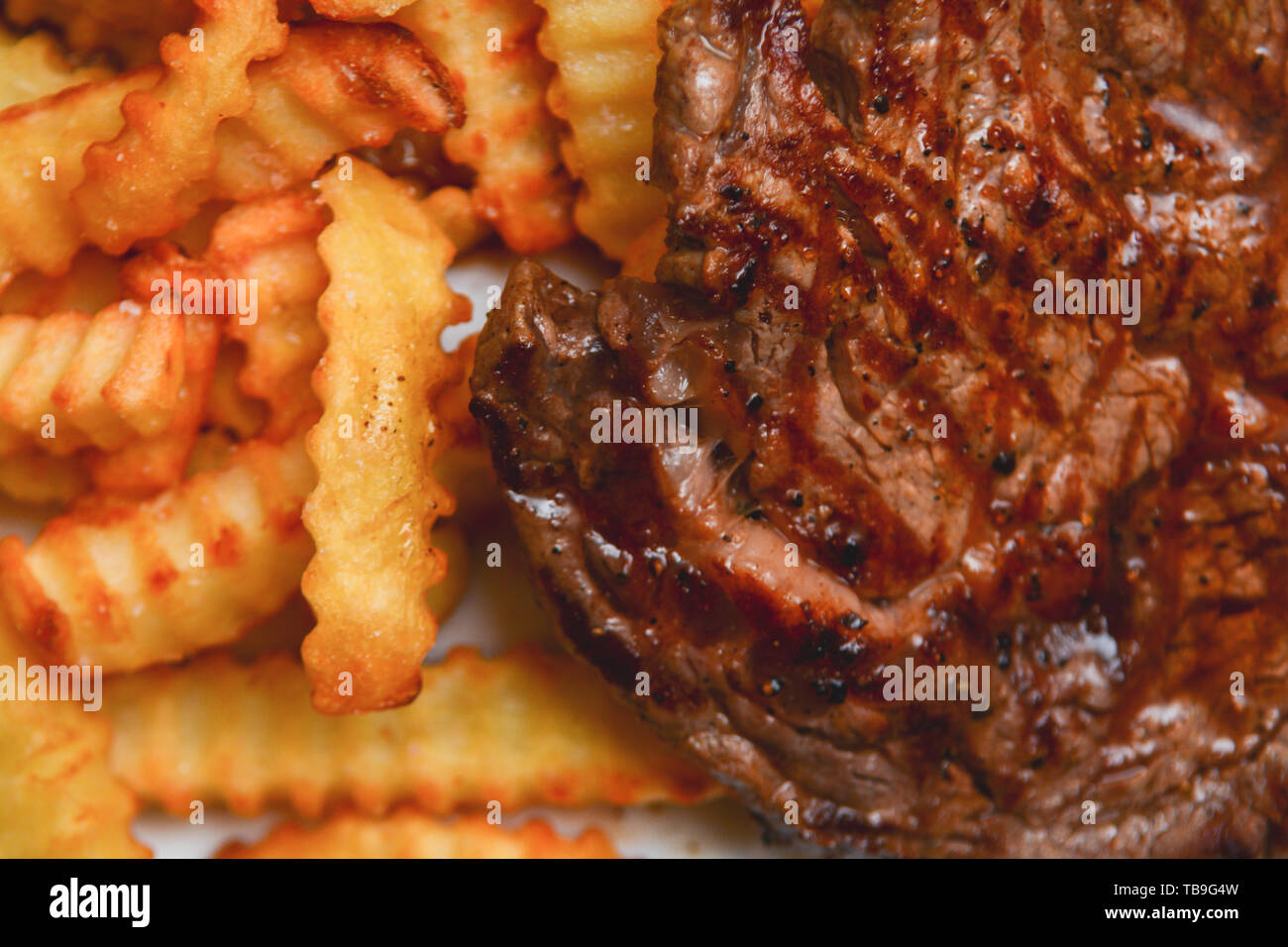 Steak and chips, tasty ribeye steak served with fries Stock Photo - Alamy