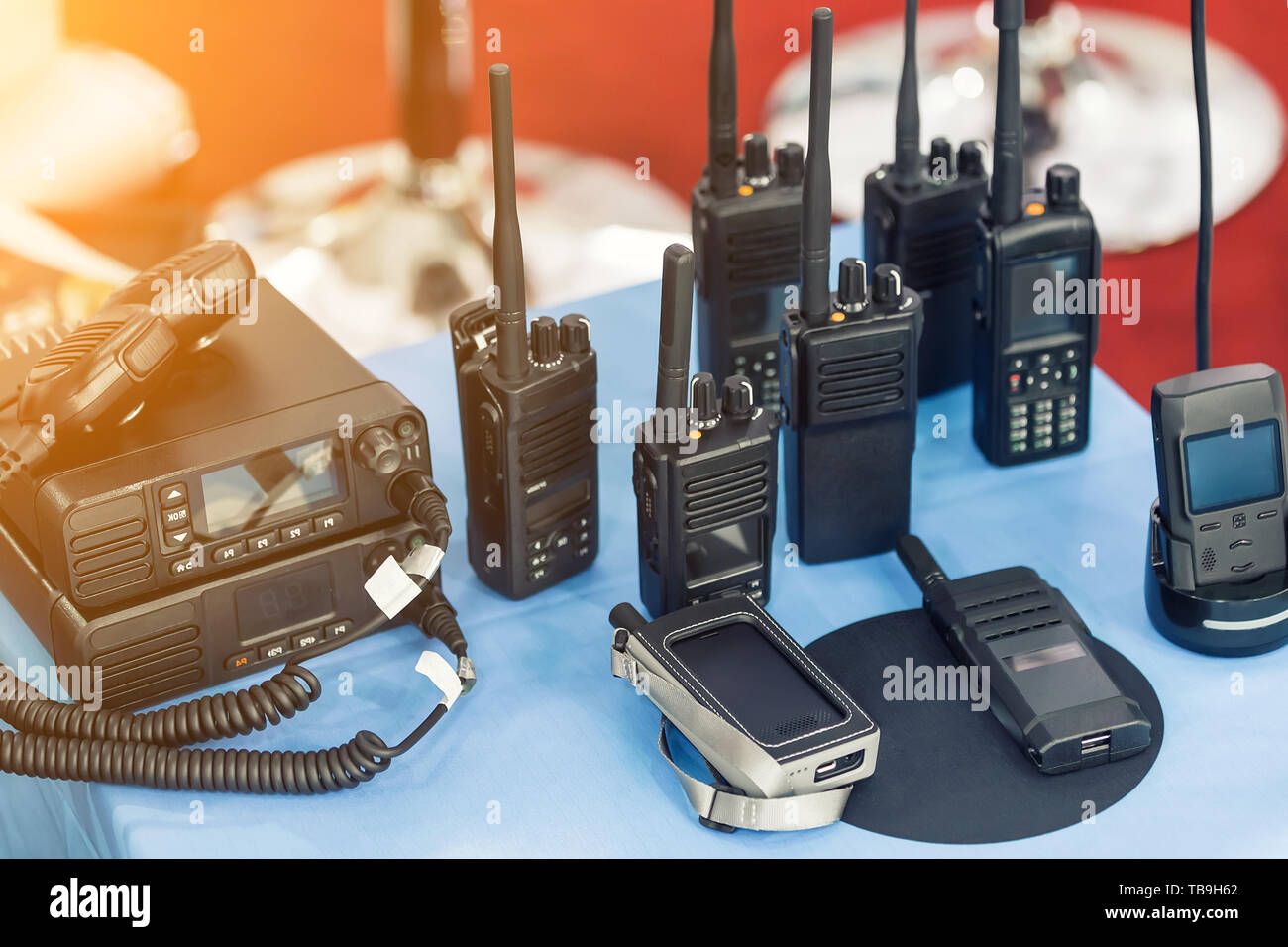 Many portable radio transceivers on table at technology exhibition