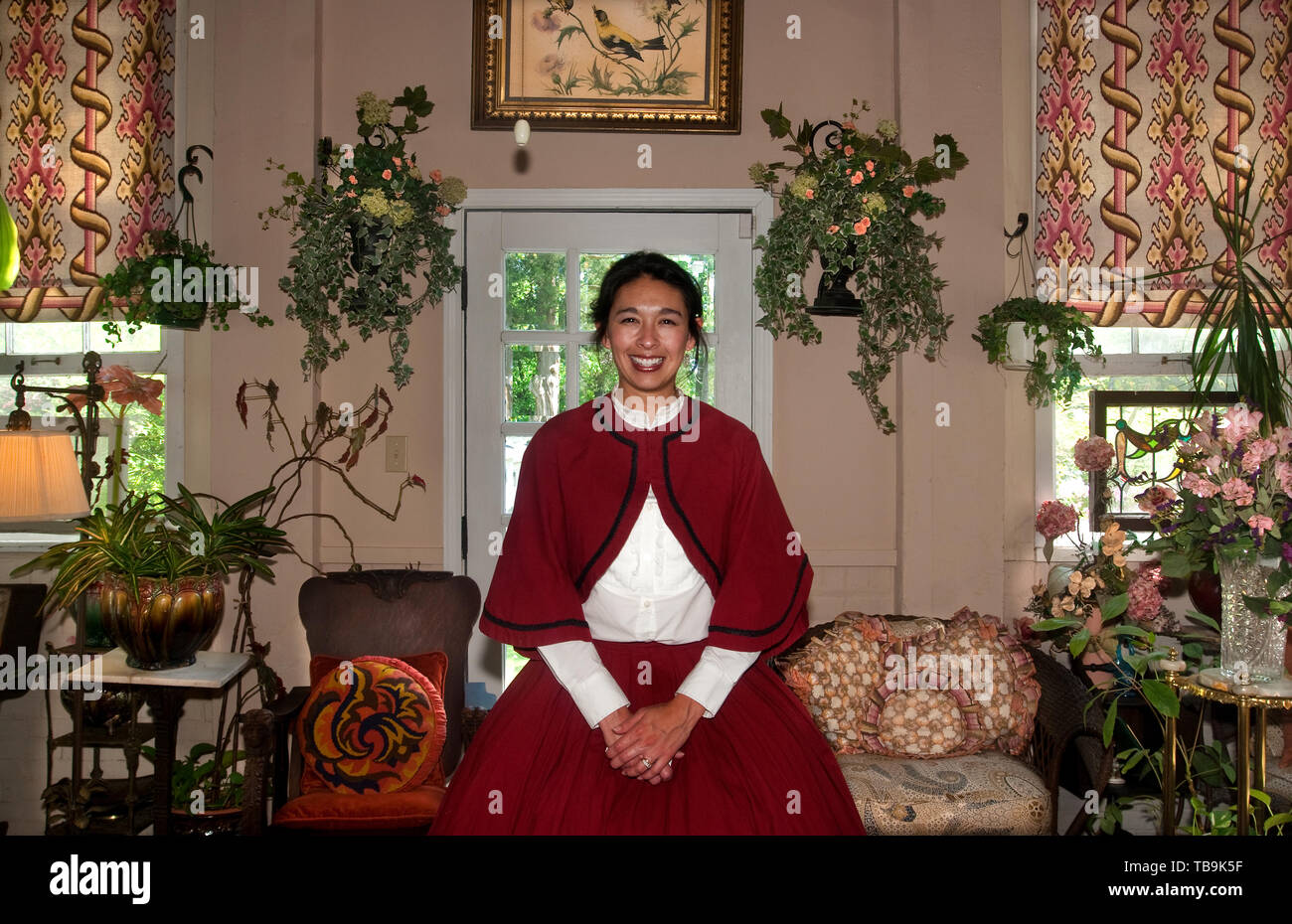 A tour guide greets guests in the sunroom at Rosewood Manor, also known as the Sykes-Leigh House, April 16, 2010, in Columbus, Mississippi. Stock Photo