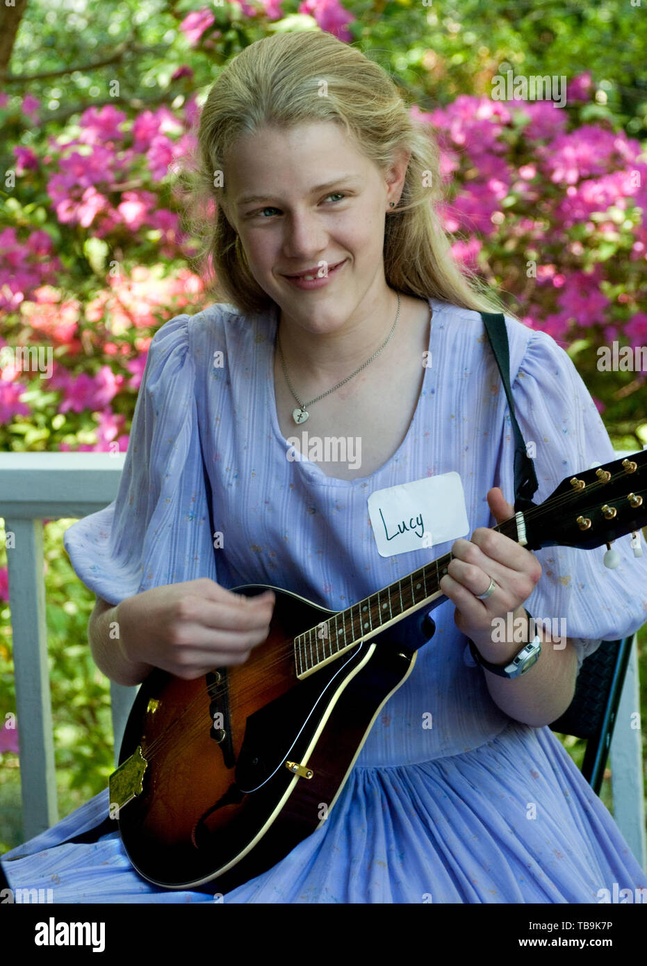 A girl plays the mandolin on the porch of Twelve Gables during the annual Spring Pilgrimage in Columbus, Mississippi, April 16, 2010. Stock Photo