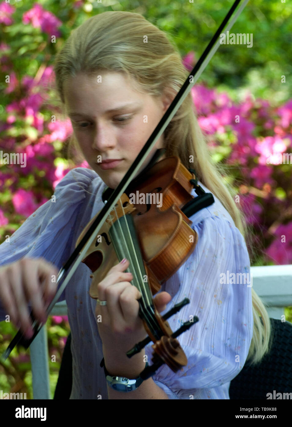 A girl plays the violin on the porch of Twelve Gables during the annual Spring Pilgrimage in Columbus, Mississippi, April 16, 2010. Stock Photo