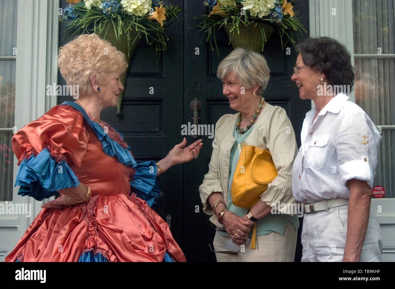 A homeowner in antebellum costume talks with tourists at Rosewood Manor in Columbus, Mississippi, April 16, 2010. Stock Photo