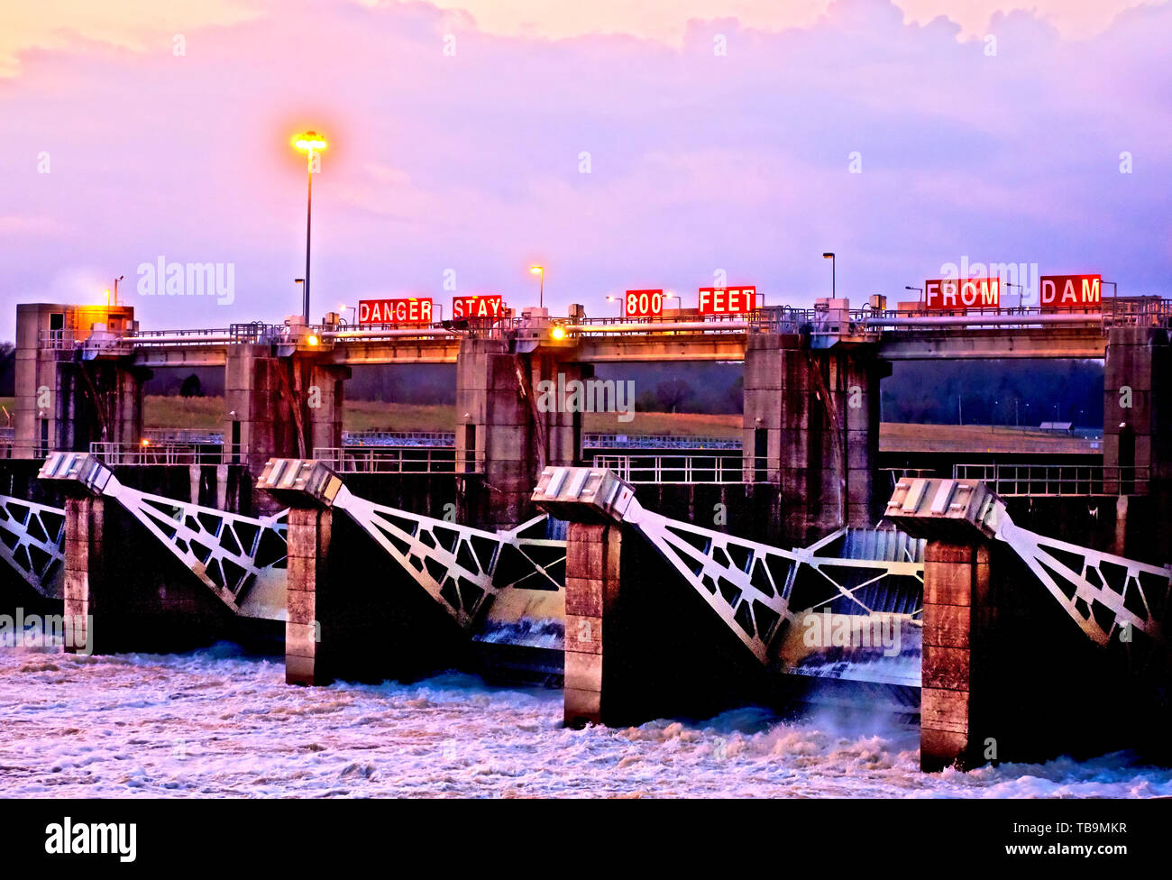The John C. Stennis Lock and Dam, formerly named Columbus Lock and Dam, is pictured with its gates open at dusk in Columbus, Mississippi. Stock Photo