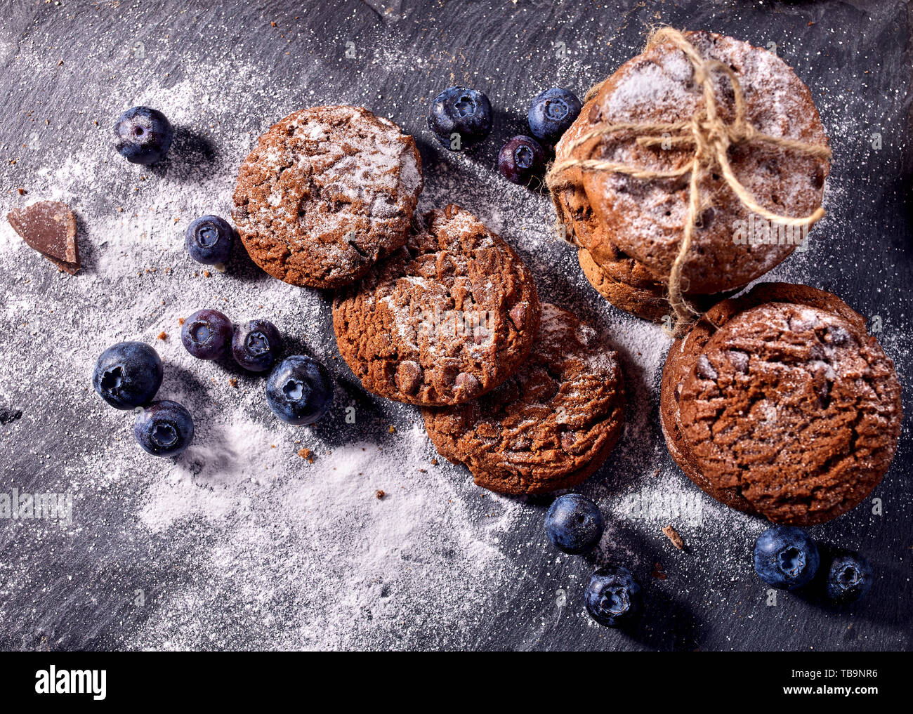 Chocolate chip cookies tied with string. Serving food on slate Stock Photo