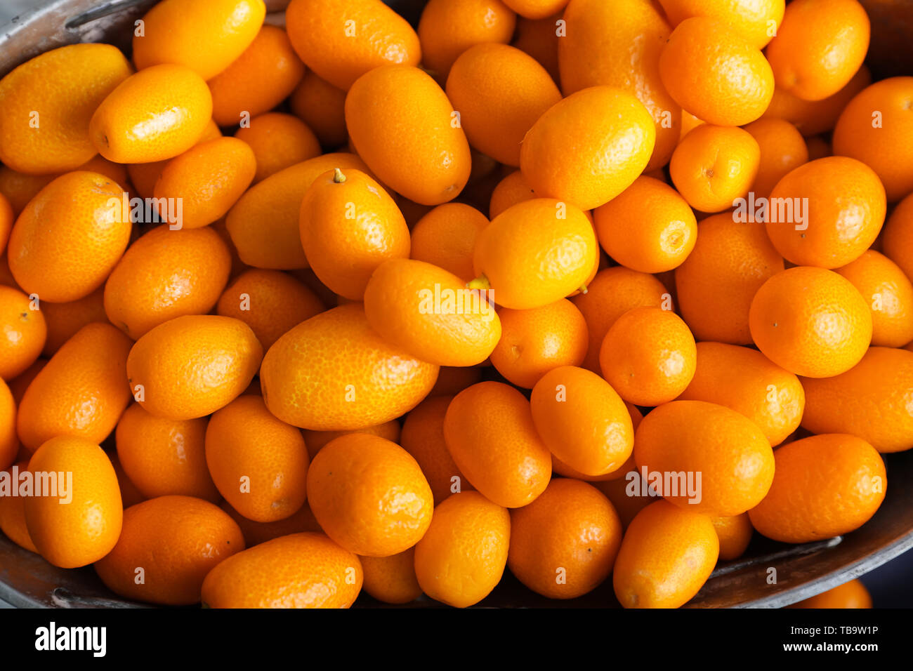 Delicious kumquat fruit in basket Stock Photo Alamy