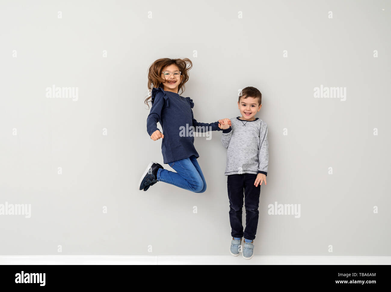 Jumping little children on white background Stock Photo - Alamy