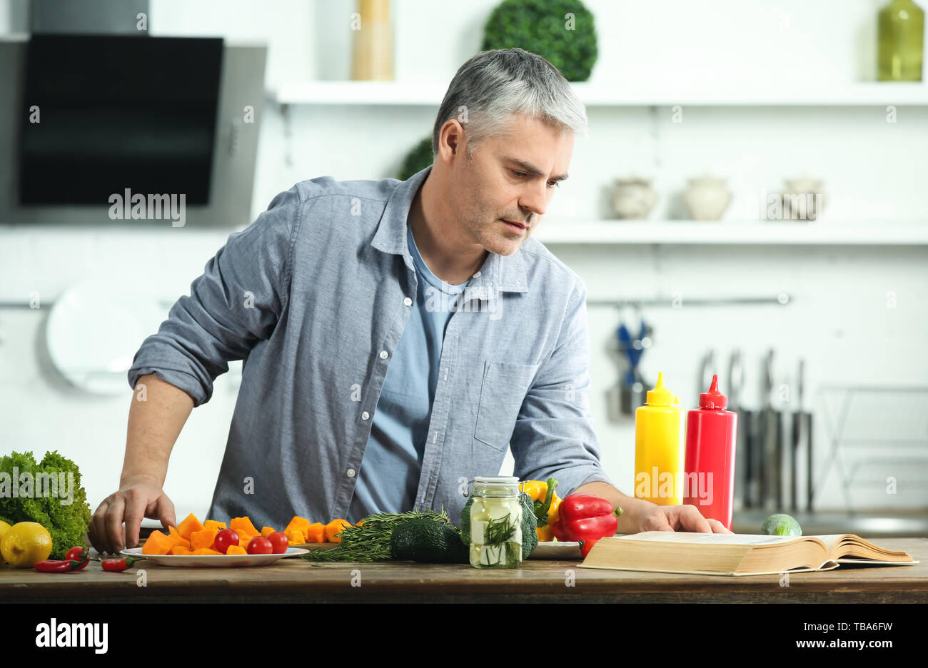 Mature man recipe book hi-res stock photography and images - Alamy