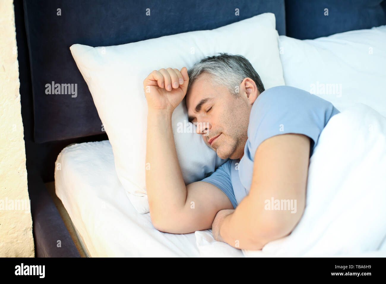 Mature man sleeping in bed at home Stock Photo - Alamy