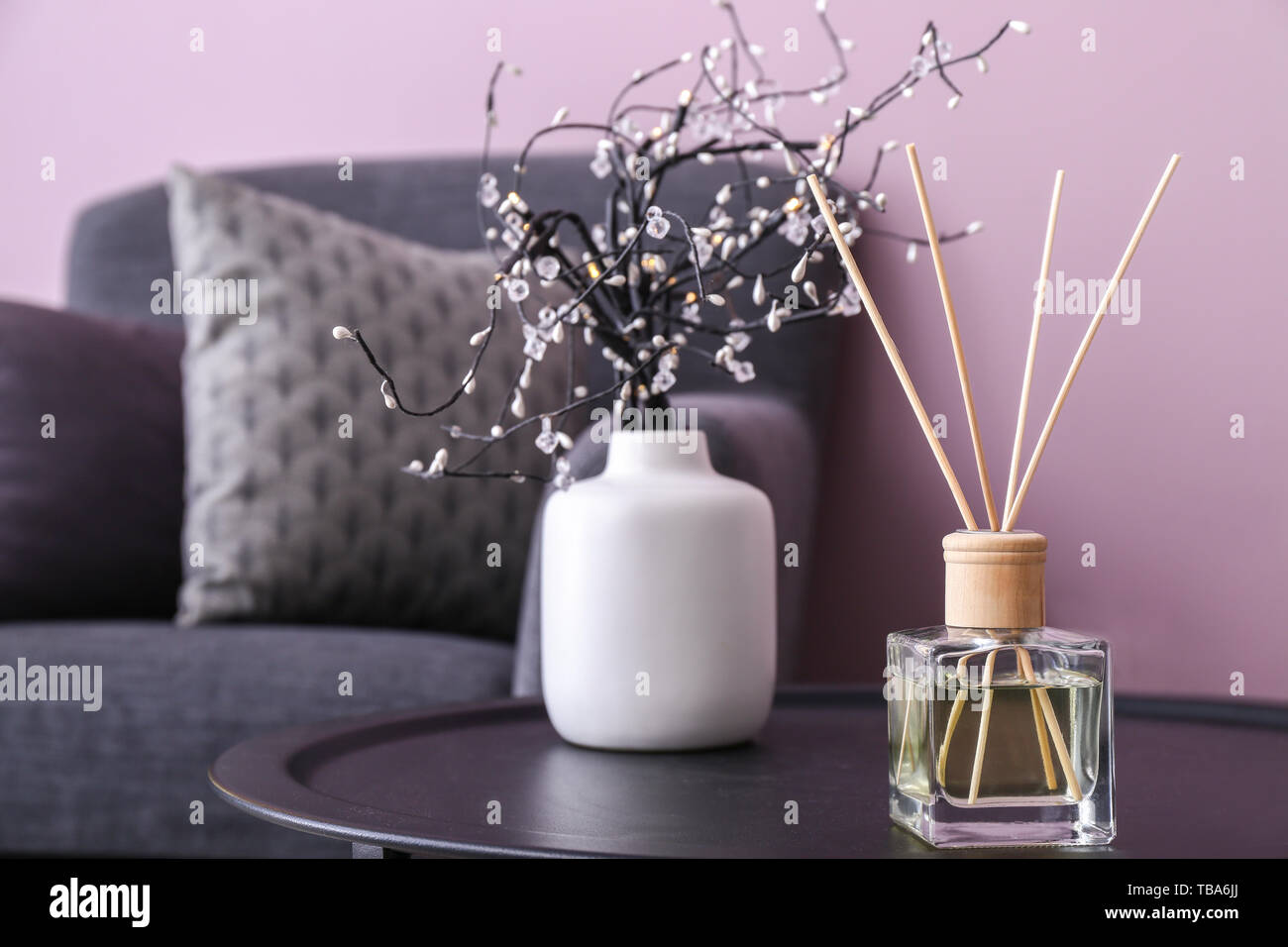 Reed diffuser on table in room Stock Photo