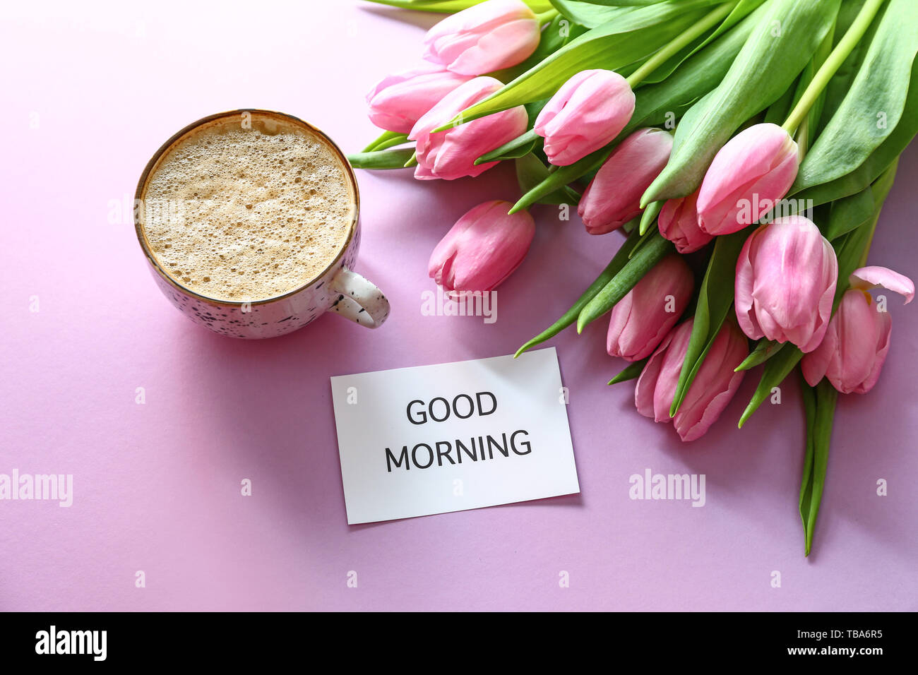 Bouquet of beautiful tulips, paper with text GOOD MORNING and cup ...