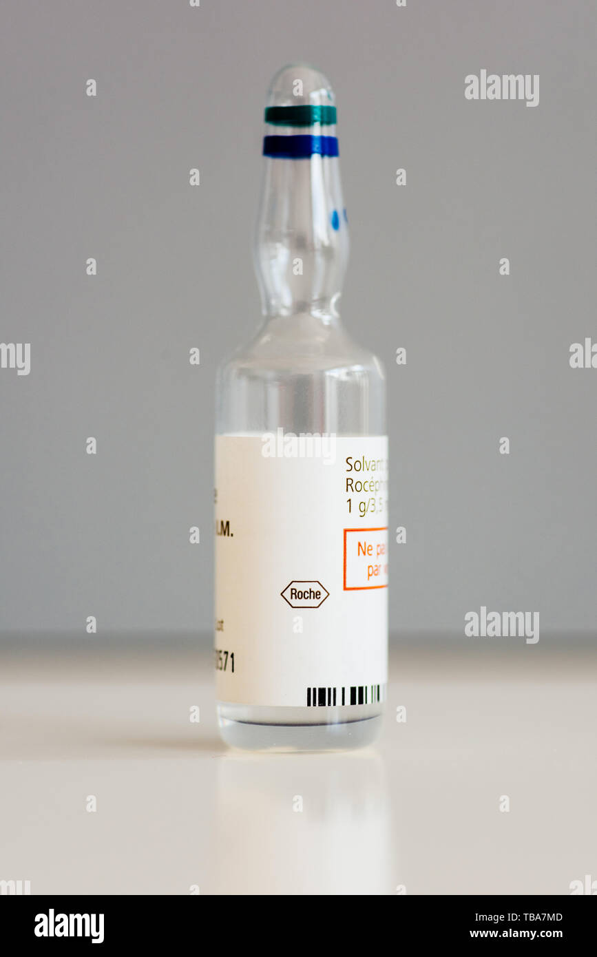 Paris, France - Apr 28, 2019: Single medical ampoule with solution isolated on white background with ROCHE F. Hoffmann-La Roche AG is a Swiss multinational healthcare company Stock Photo