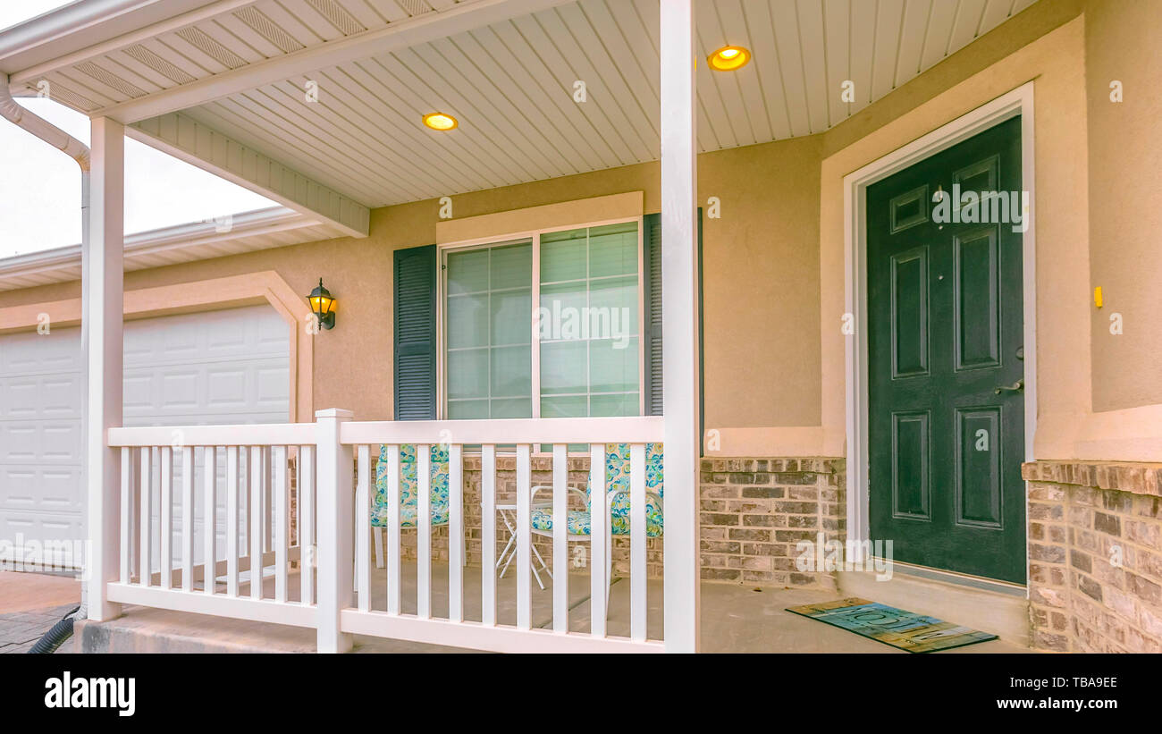 frame Panorama Home facade with yard and stairs in front of the small ...