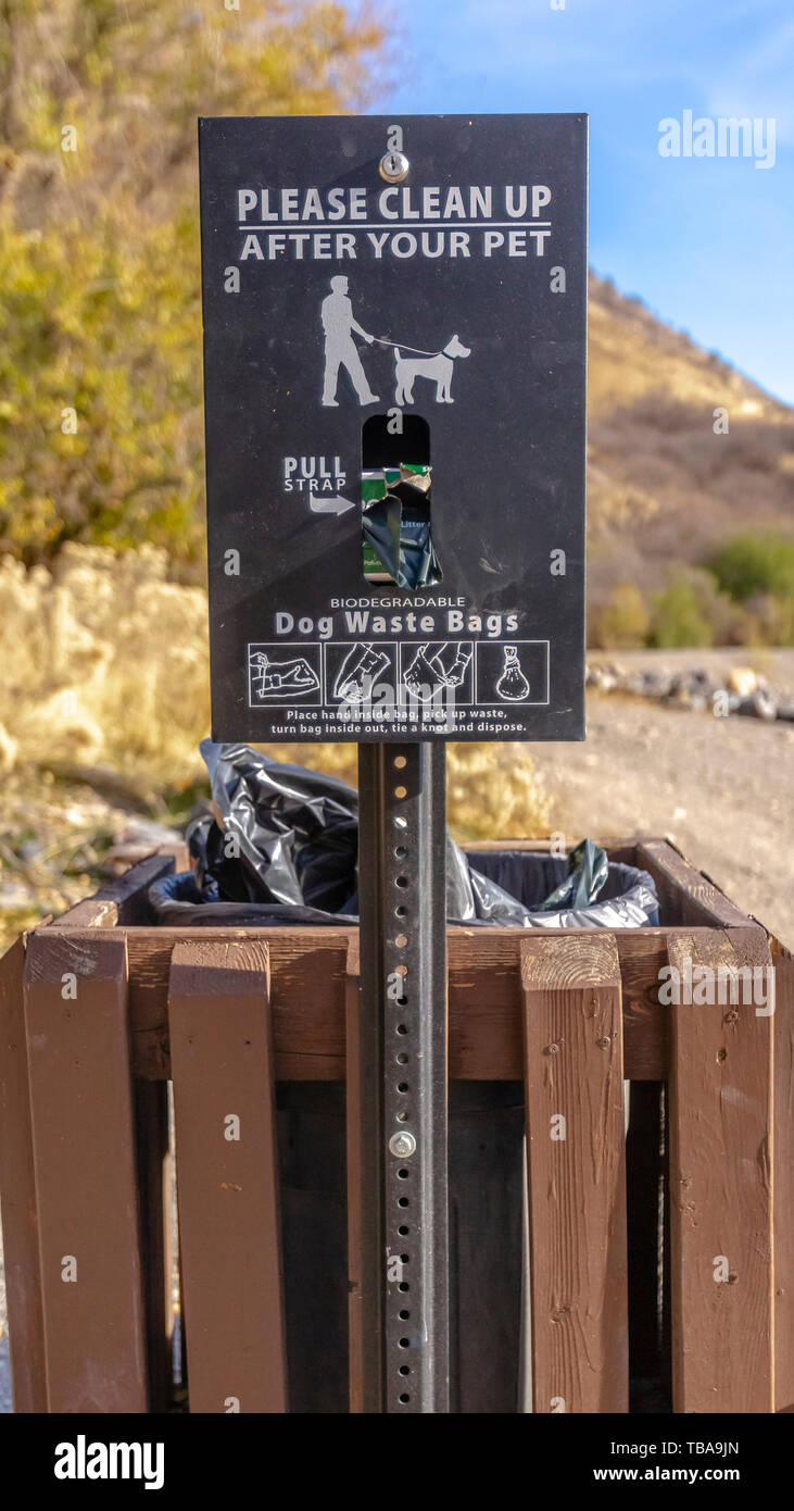 frame Vertical Dog Waste Basket with a sign that reads Please Clean Up