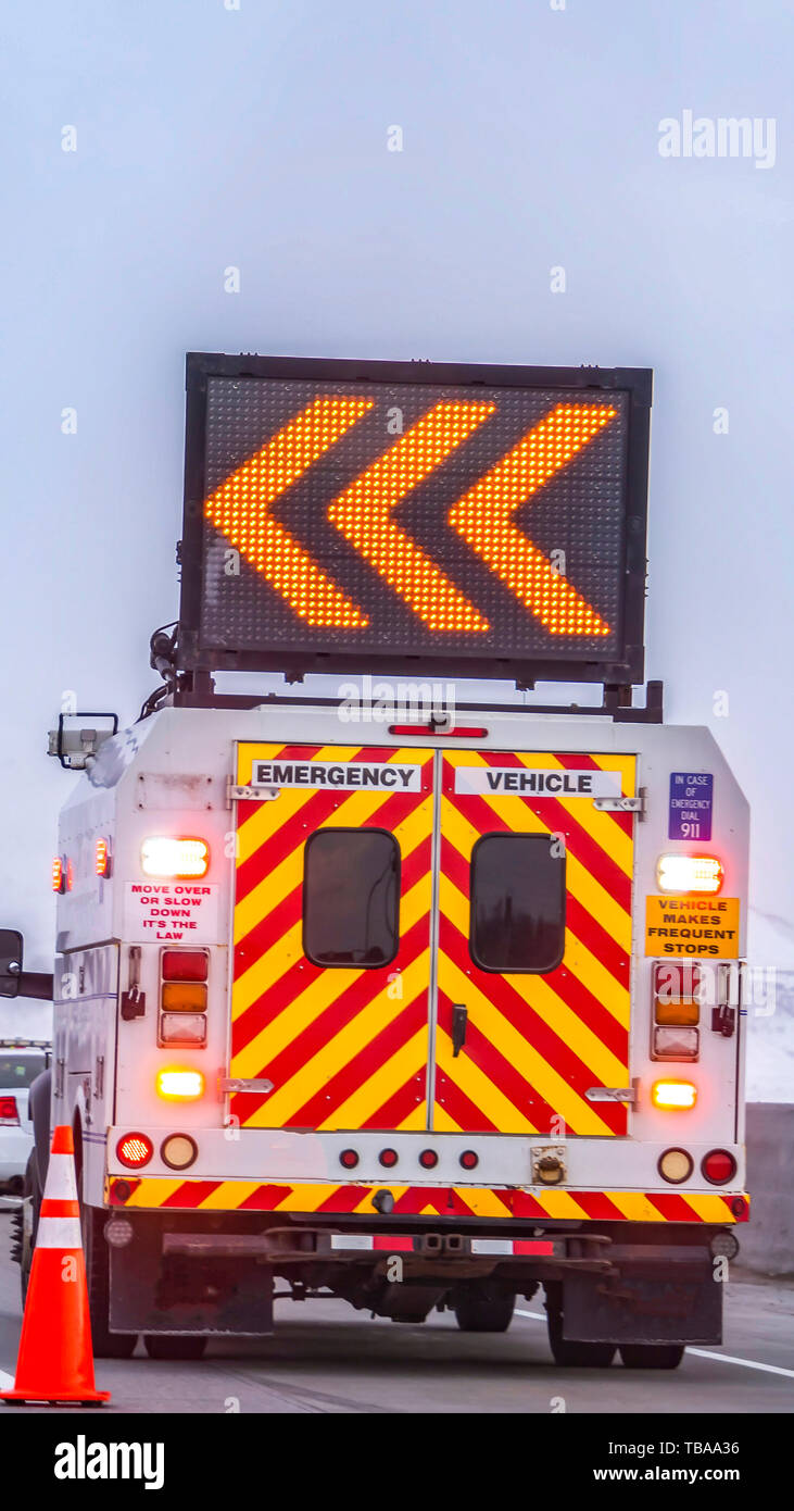 Vertical frame Back view of an emergency vehicle with an arrow board