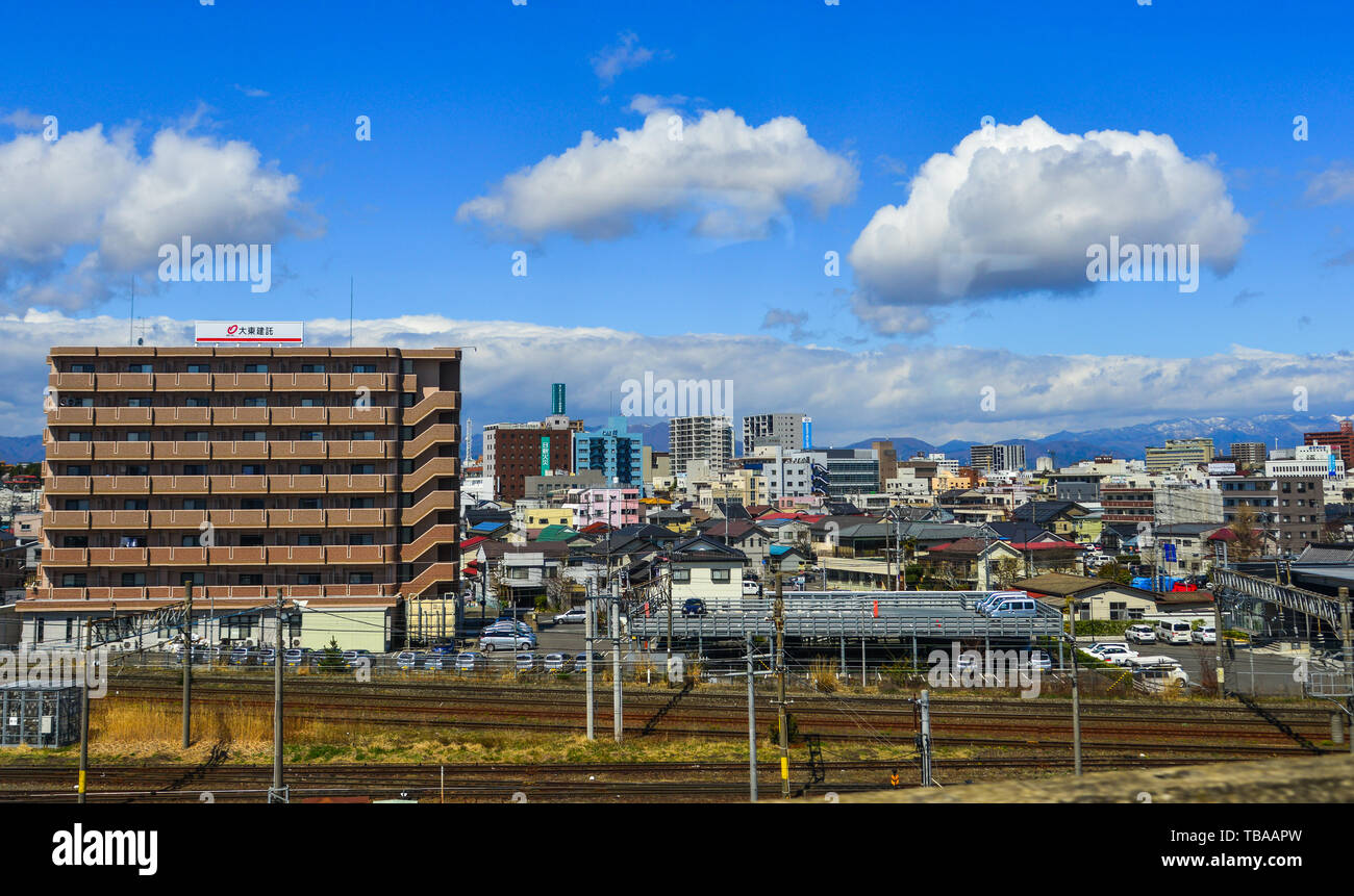 Fukushima, Japan - Apr 15, 2019. Cityscape with snow mountain in Fukushima, Japan. Fukushima is the place where the nuclear disaster occurred in 2011. Stock Photo