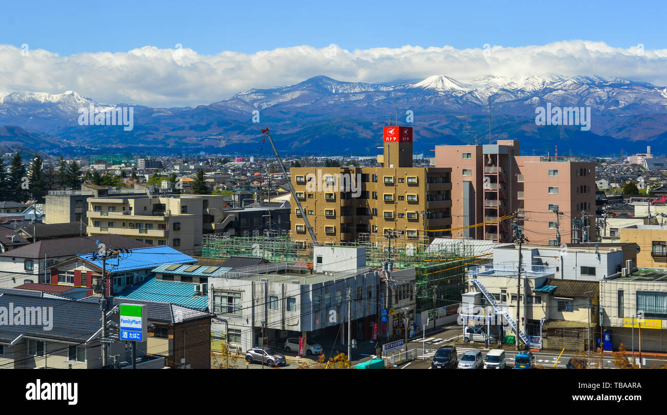 Fukushima, Japan - Apr 15, 2019. Cityscape with snow mountain in Fukushima, Japan. Fukushima is the place where the nuclear disaster occurred in 2011. Stock Photo