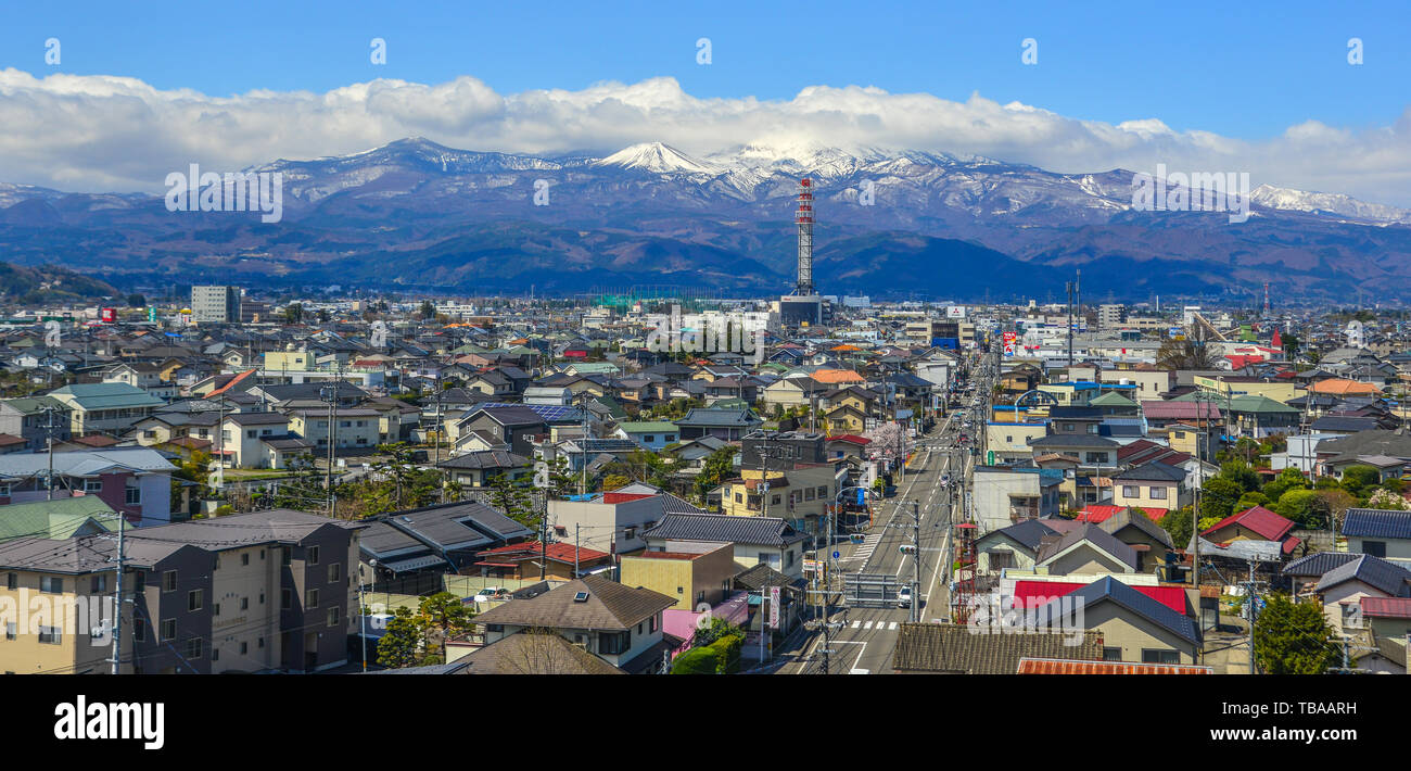 Fukushima, Japan - Apr 15, 2019. Cityscape with snow mountain in Fukushima, Japan. Fukushima is the place where the nuclear disaster occurred in 2011. Stock Photo