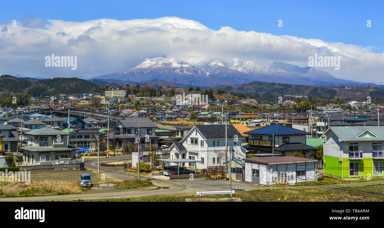 Fukushima, Japan - Apr 15, 2019. Cityscape with snow mountain in Fukushima, Japan. Fukushima is the place where the nuclear disaster occurred in 2011. Stock Photo