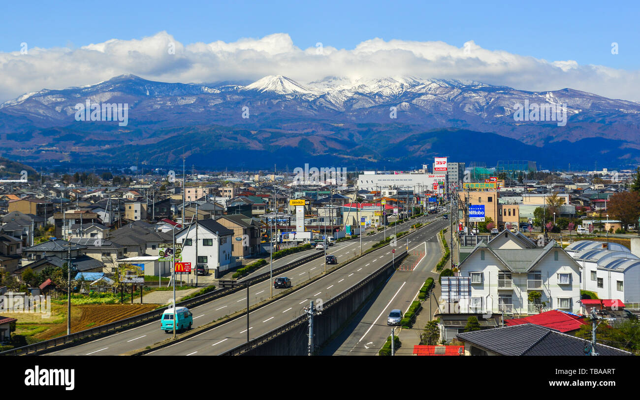 Fukushima, Japan - Apr 15, 2019. Cityscape with snow mountain in Fukushima, Japan. Fukushima is the place where the nuclear disaster occurred in 2011. Stock Photo