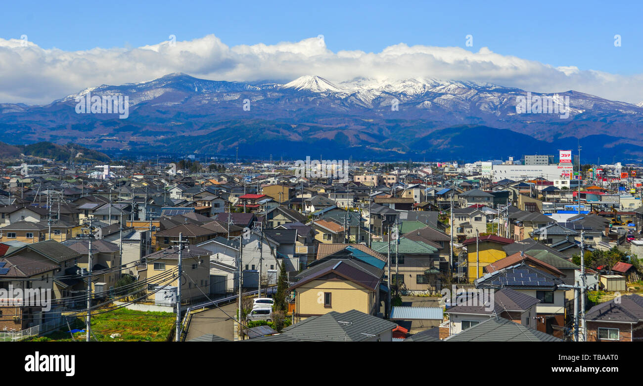 Fukushima, Japan - Apr 15, 2019. Cityscape with snow mountain in Fukushima, Japan. Fukushima is the place where the nuclear disaster occurred in 2011. Stock Photo