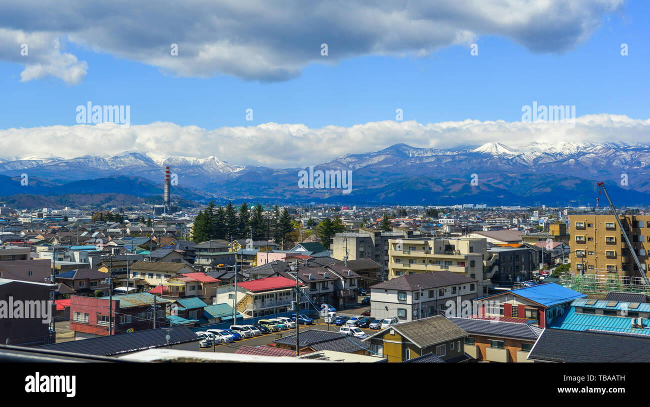 Fukushima, Japan - Apr 15, 2019. Cityscape with snow mountain in Fukushima, Japan. Fukushima is the place where the nuclear disaster occurred in 2011. Stock Photo