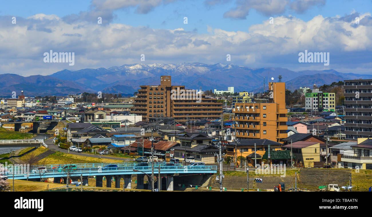 Fukushima, Japan - Apr 15, 2019. Cityscape with snow mountain in Fukushima, Japan. Fukushima is the place where the nuclear disaster occurred in 2011. Stock Photo