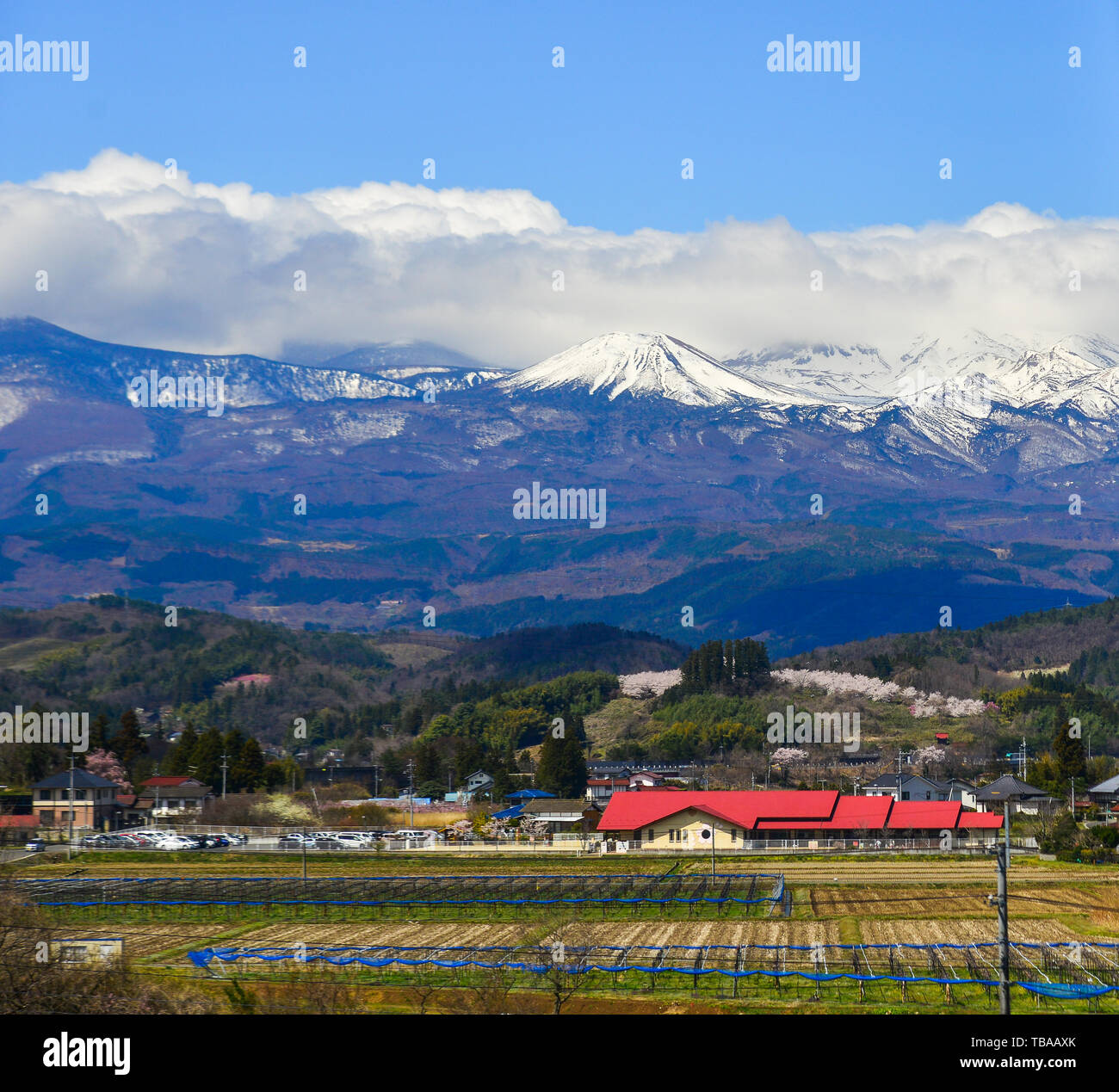 Small town with snow mountain in Fukushima, Japan. Fukushima is the place where the nuclear disaster occurred in 2011. Stock Photo