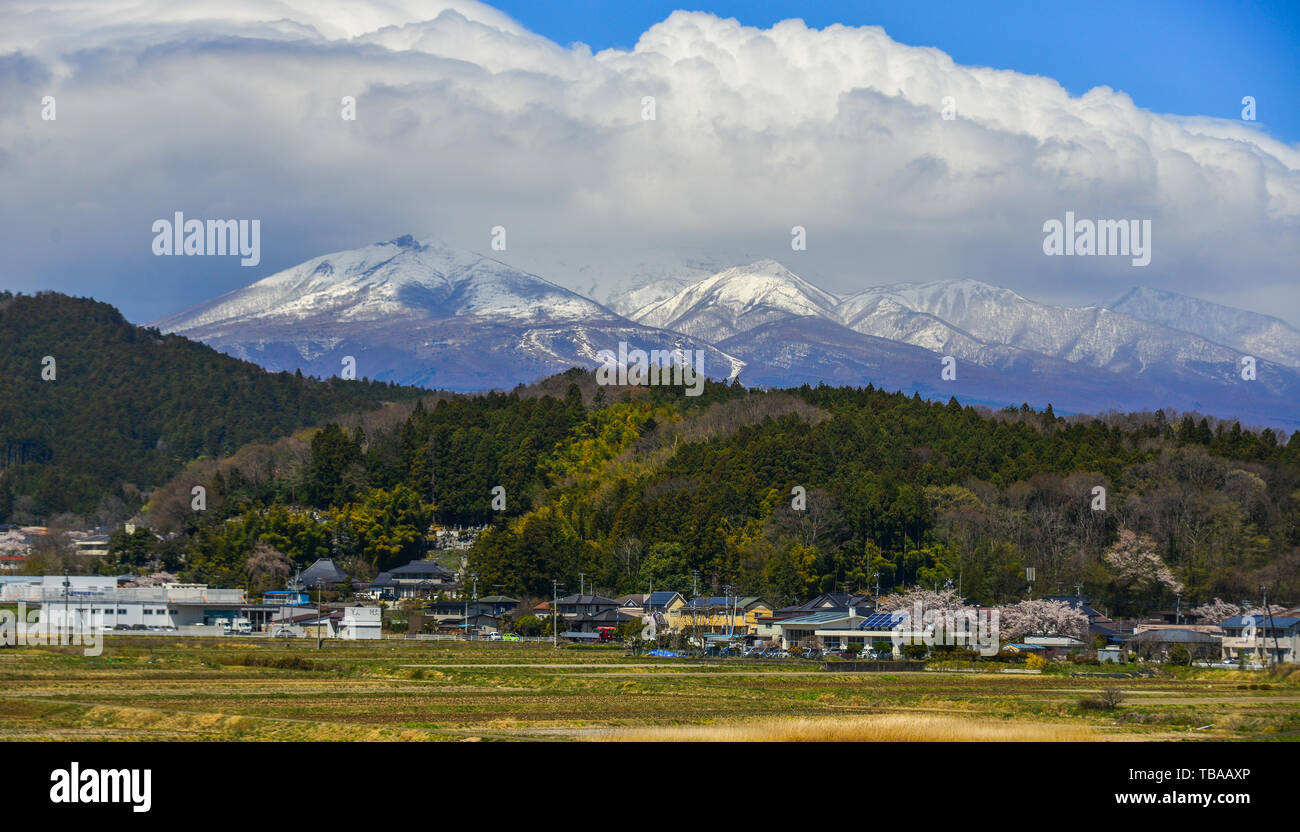 Small town with snow mountain in Fukushima, Japan. Fukushima is the place where the nuclear disaster occurred in 2011. Stock Photo