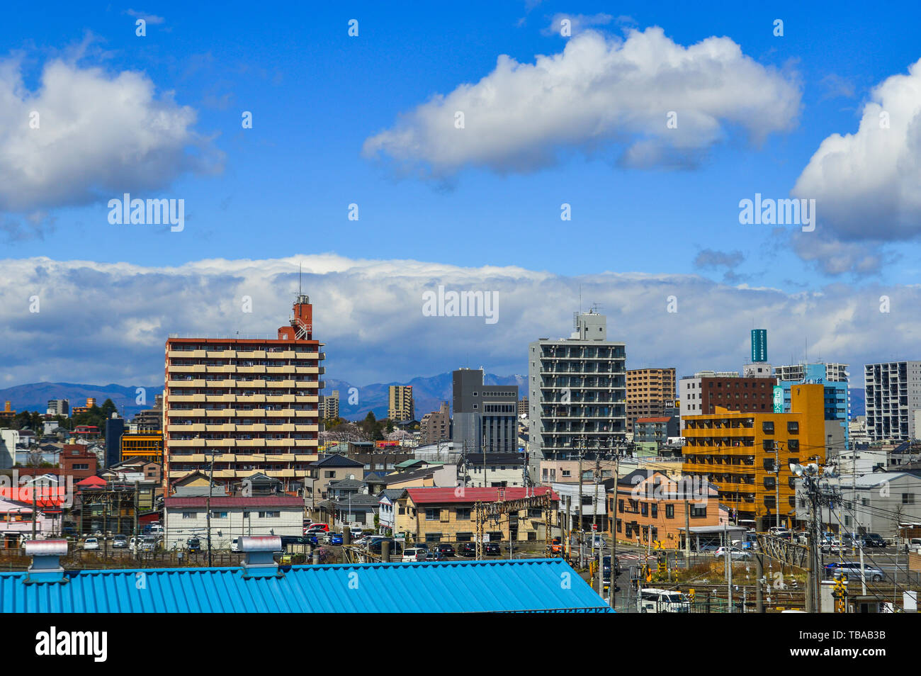 Fukushima, Japan - Apr 15, 2019. Cityscape with snow mountain in Fukushima, Japan. Fukushima is the place where the nuclear disaster occurred in 2011. Stock Photo